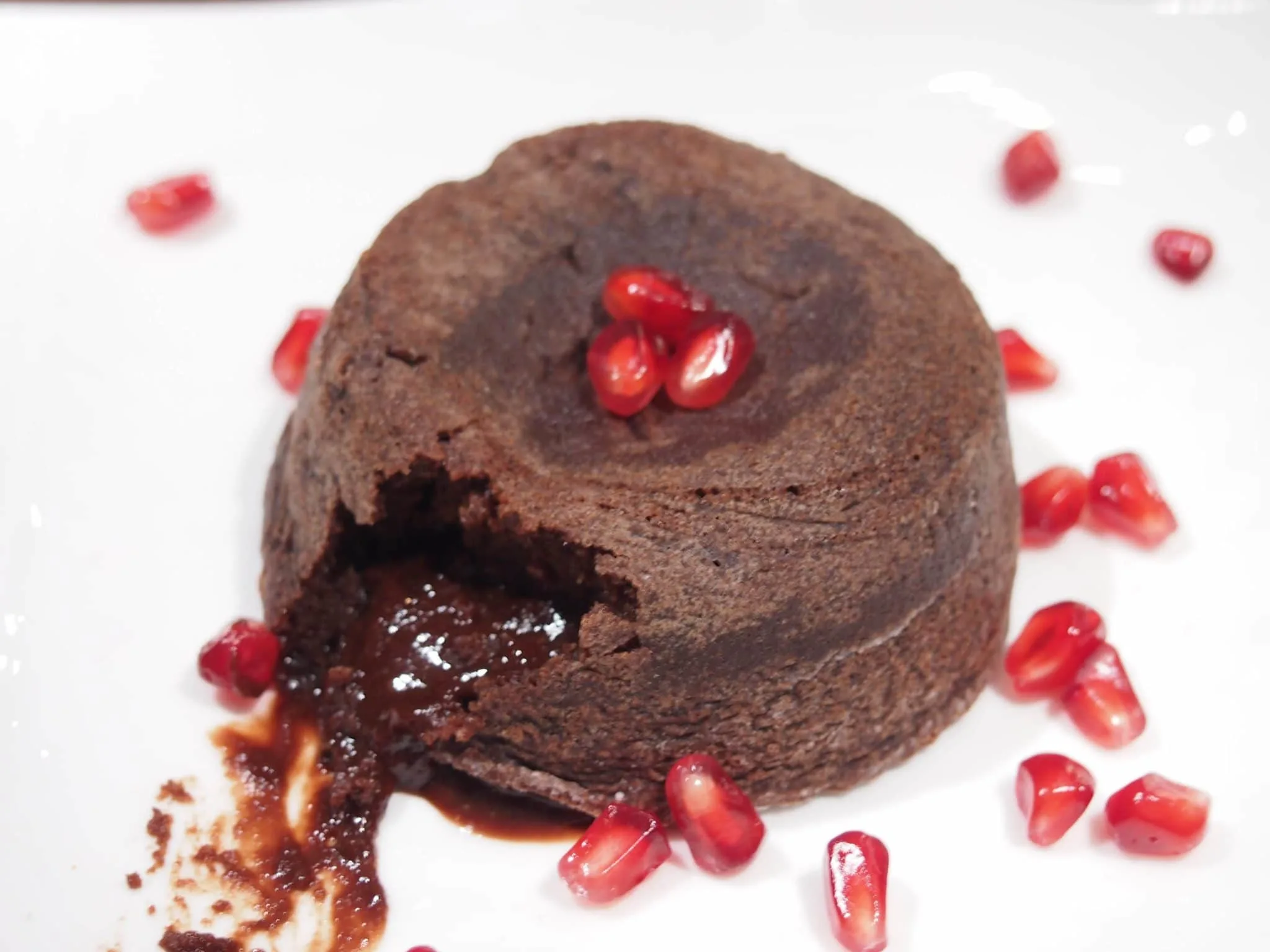 Molten Chocolate Cake on dish with chocolate oozing out of cake.