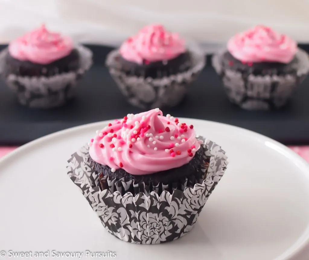 Chocolate beetroot cupcakes with cream cheese icing on cake stand.