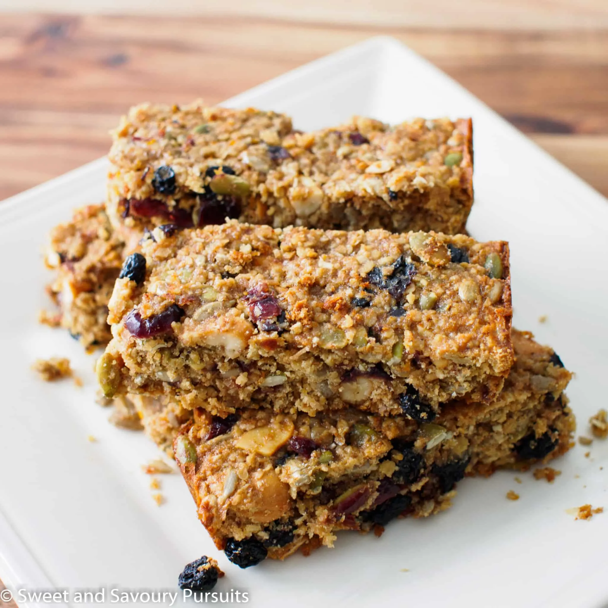 Dried fruit and seed bars on dish.