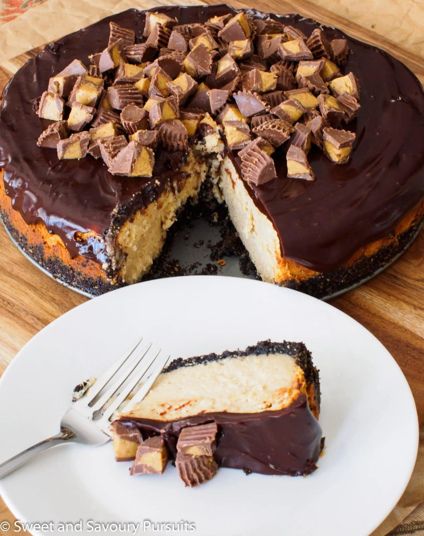 Slice of peanut butter and chocolate cheesecake on dish.