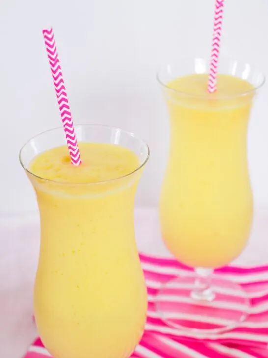 Two Pineapple, Mango and Orange Smoothies.