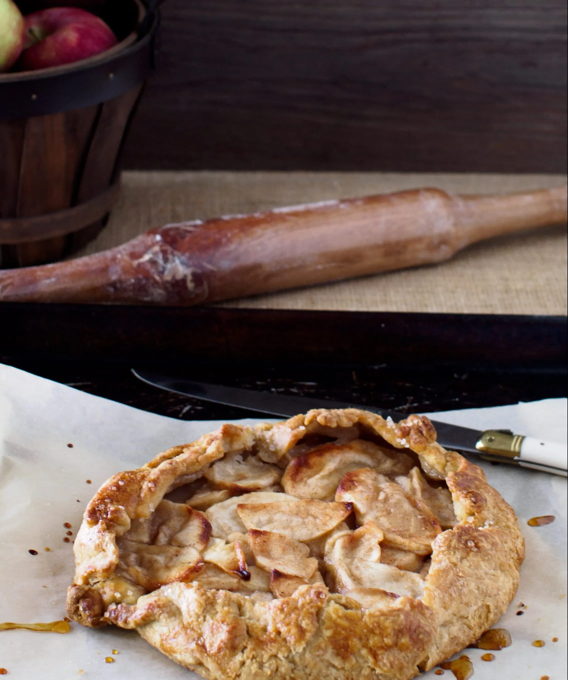 Spiced Apple Galette on baking sheet with knife