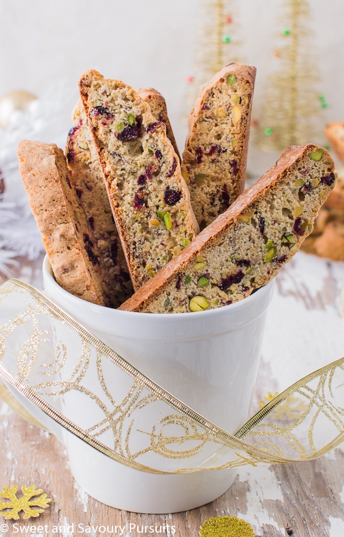 Pistachio and Cranberry Biscotti displayed in mug.