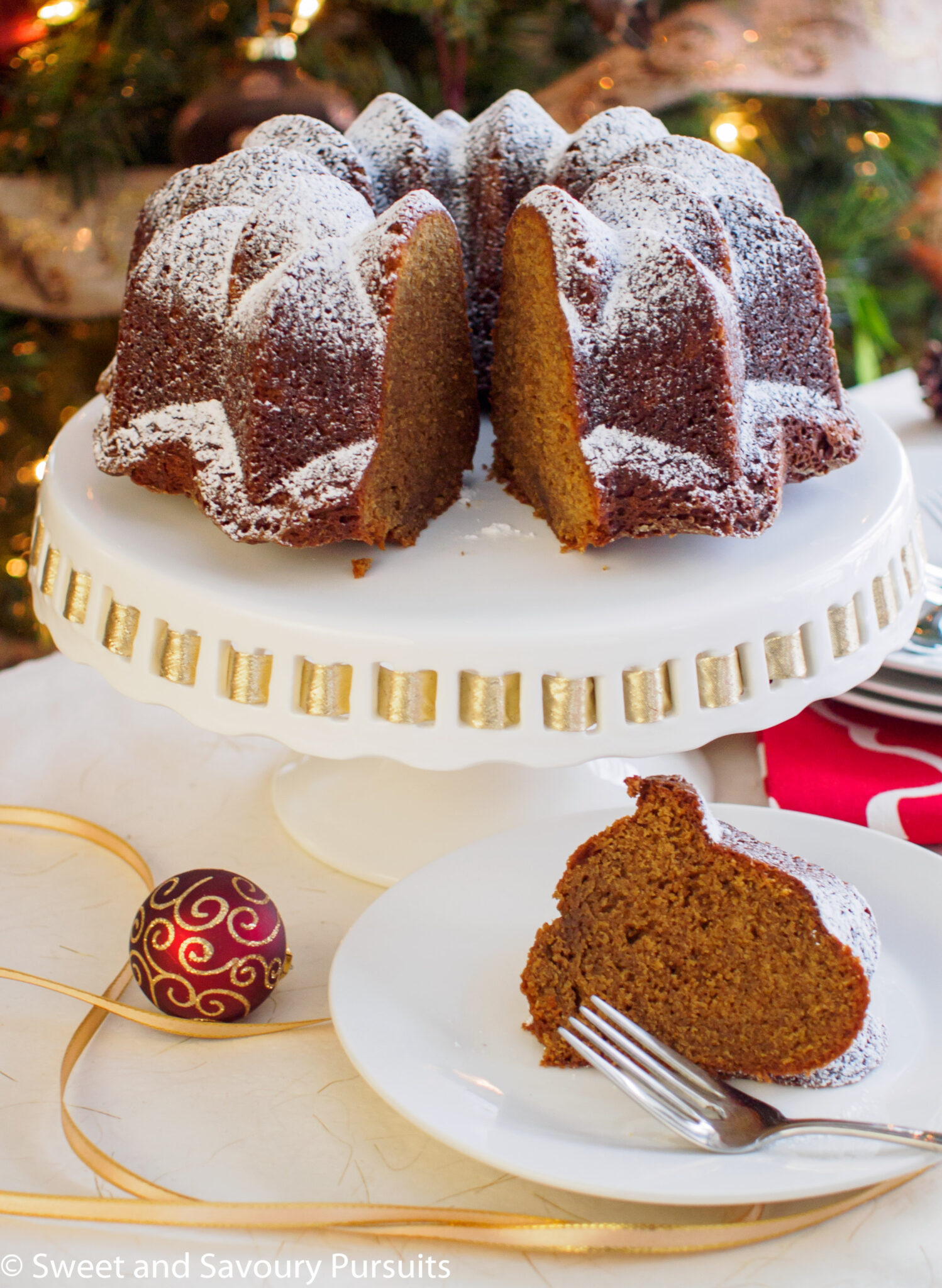 Gingerbread bundt cake with slice cut out and served on dish.