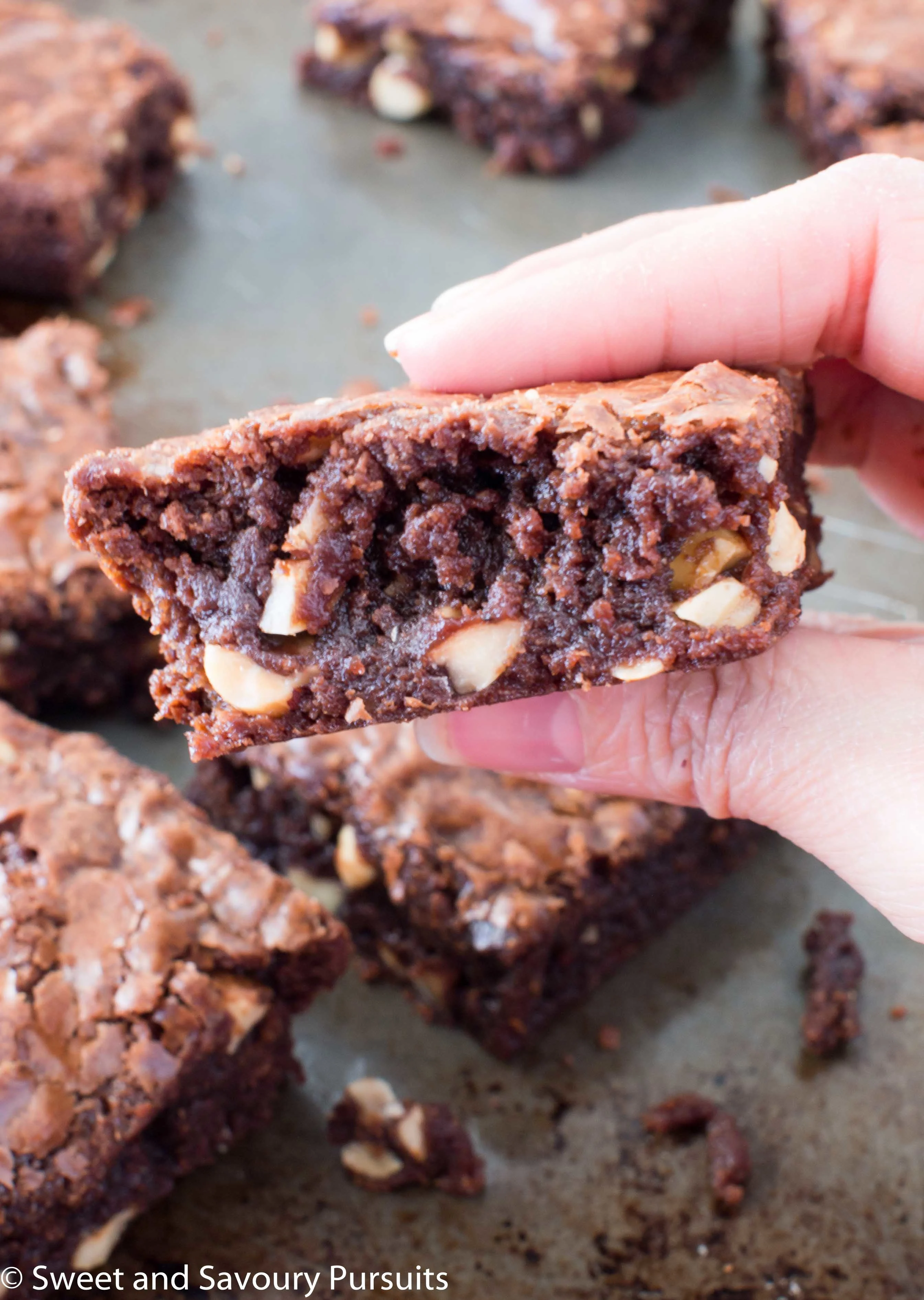 Close-up of a slice of fudgy Nutella brownie with hazelnut pieces.