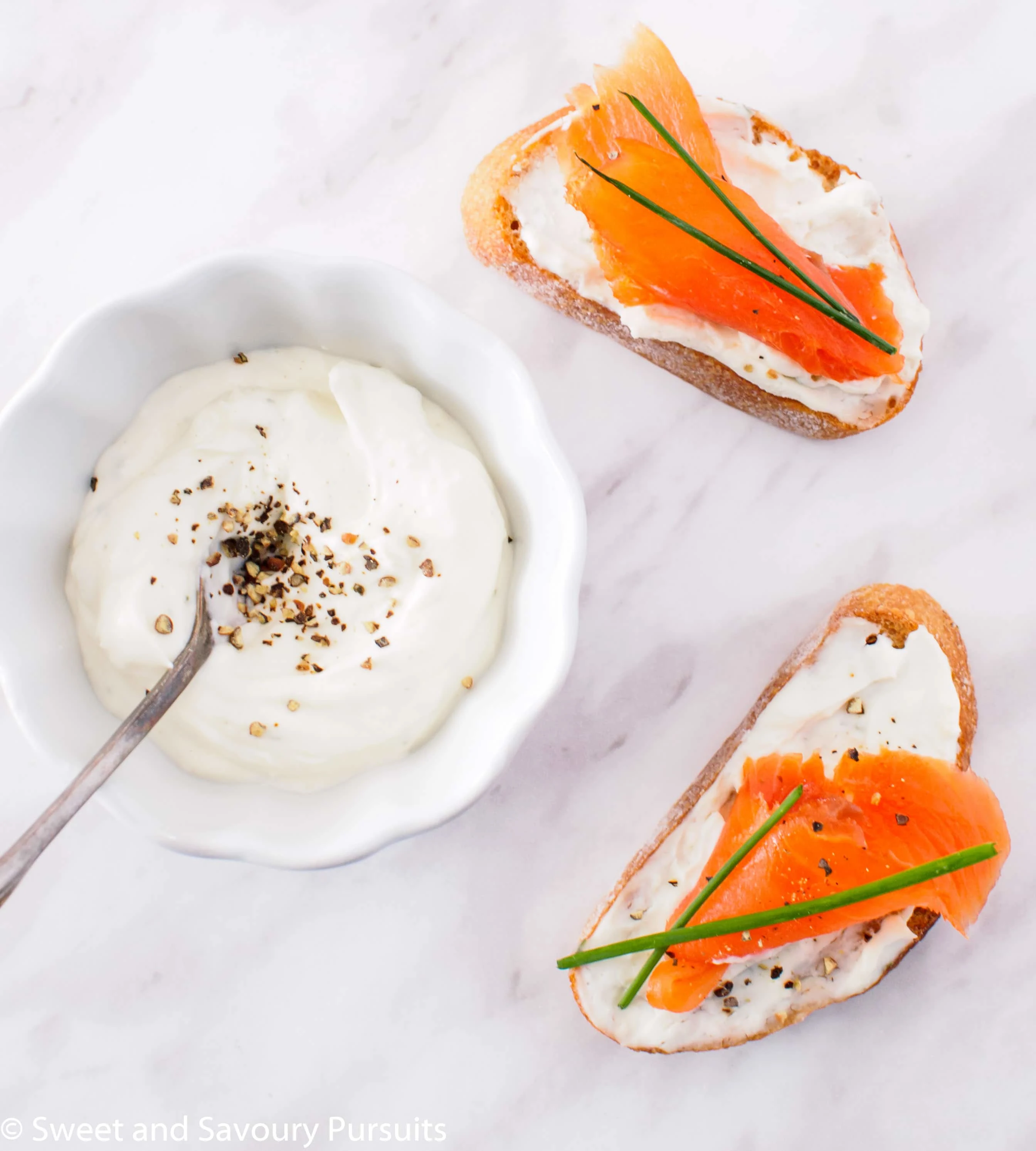 Top view of Smoked Salmon and Boursin Crostini with chives.