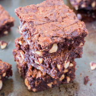 Three Nutella and Hazelnut Brownies stacked on top of each other on a baking tray.