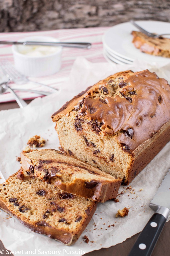 Peanut Butter and Chocolate Chip Loaf on cutting board with cut slices.