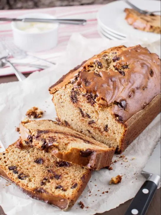 Peanut Butter and Chocolate Chip Loaf on cutting board with cut slices.