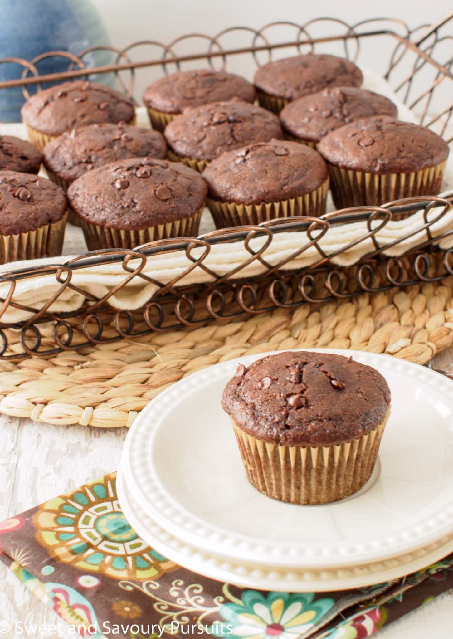 Whole wheat chocolate zucchini muffin on dish.