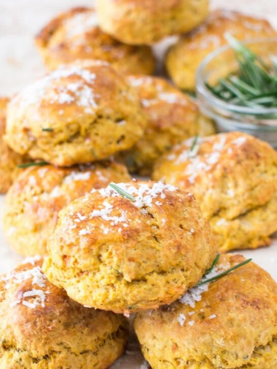 Sweet potato biscuits topped with sprinkling of Parmesan cheese and fresh rosemary.