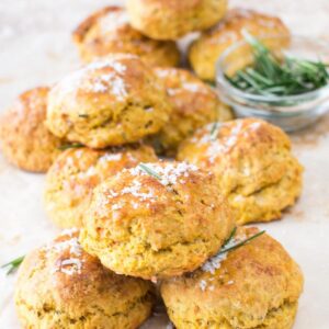 Sweet potato biscuits topped with sprinkling of Parmesan cheese and fresh rosemary.