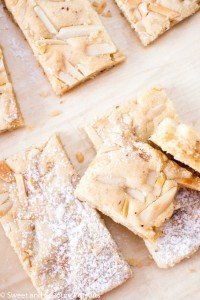 Almond Marzipan Bars partially dusted with icing sugar on board.