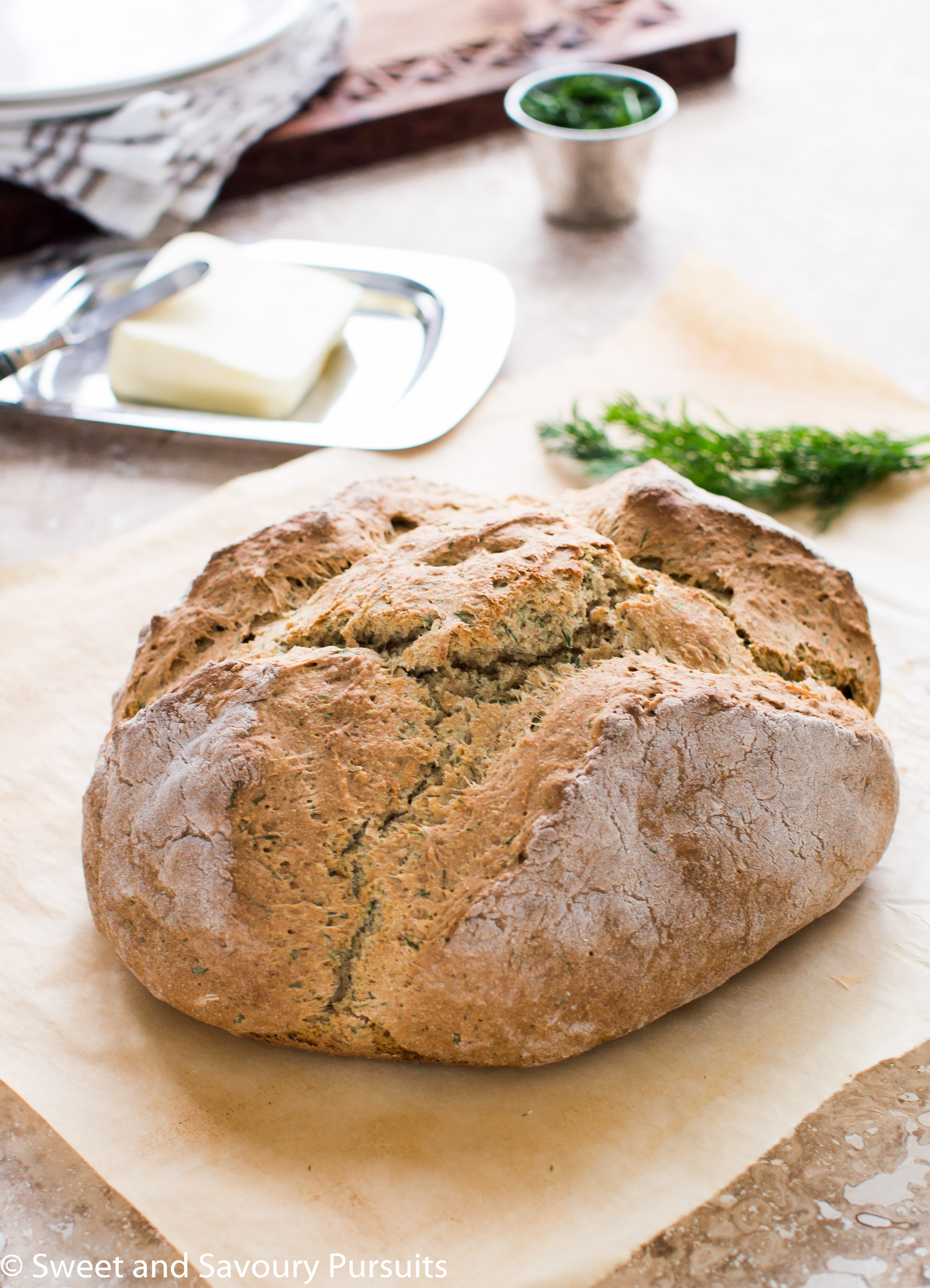 Loaf of Irish Soda Bread with Dill on parchment paper.