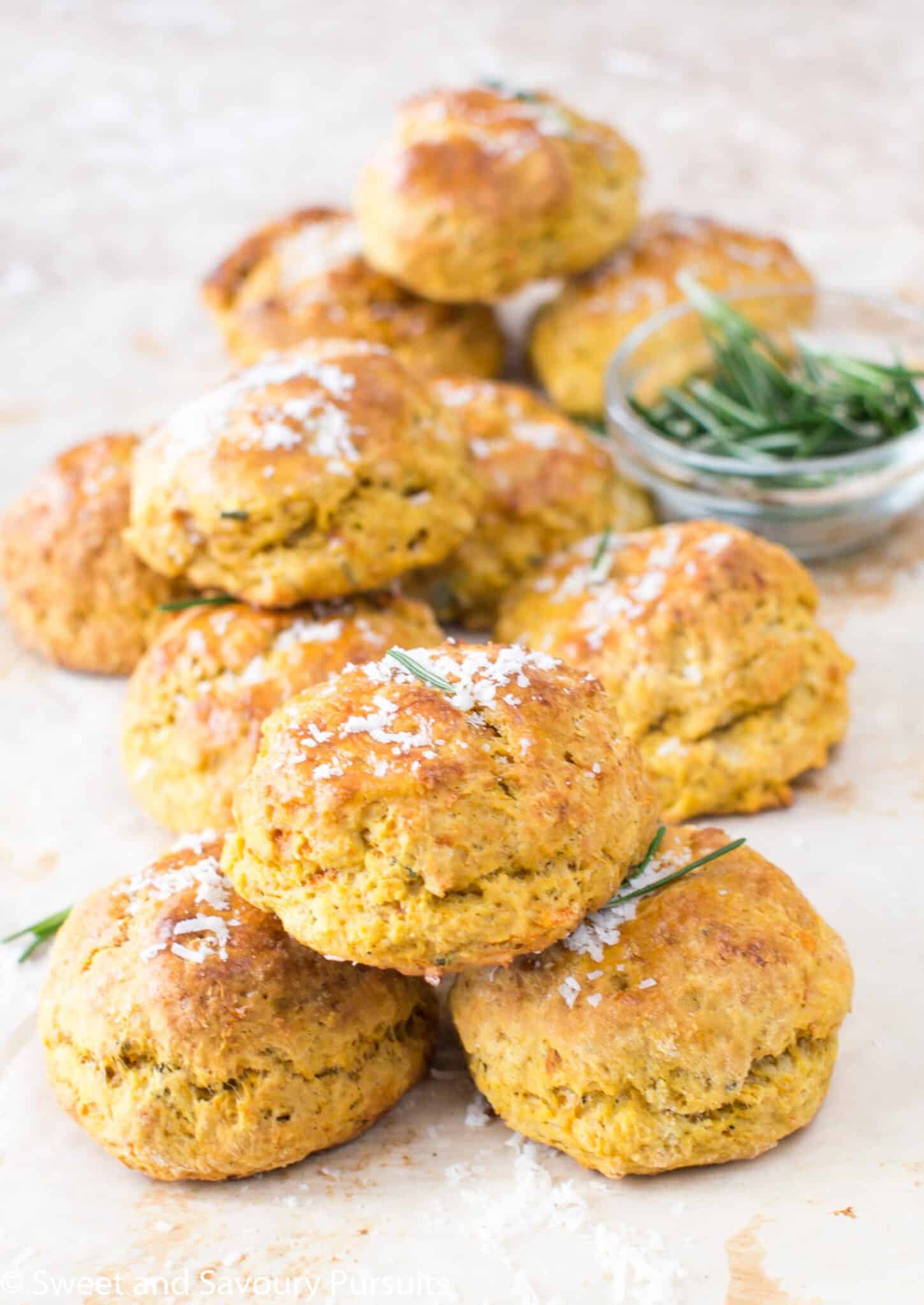 A freshly baked sweet potato biscuit cut in half with butter smeared on it.