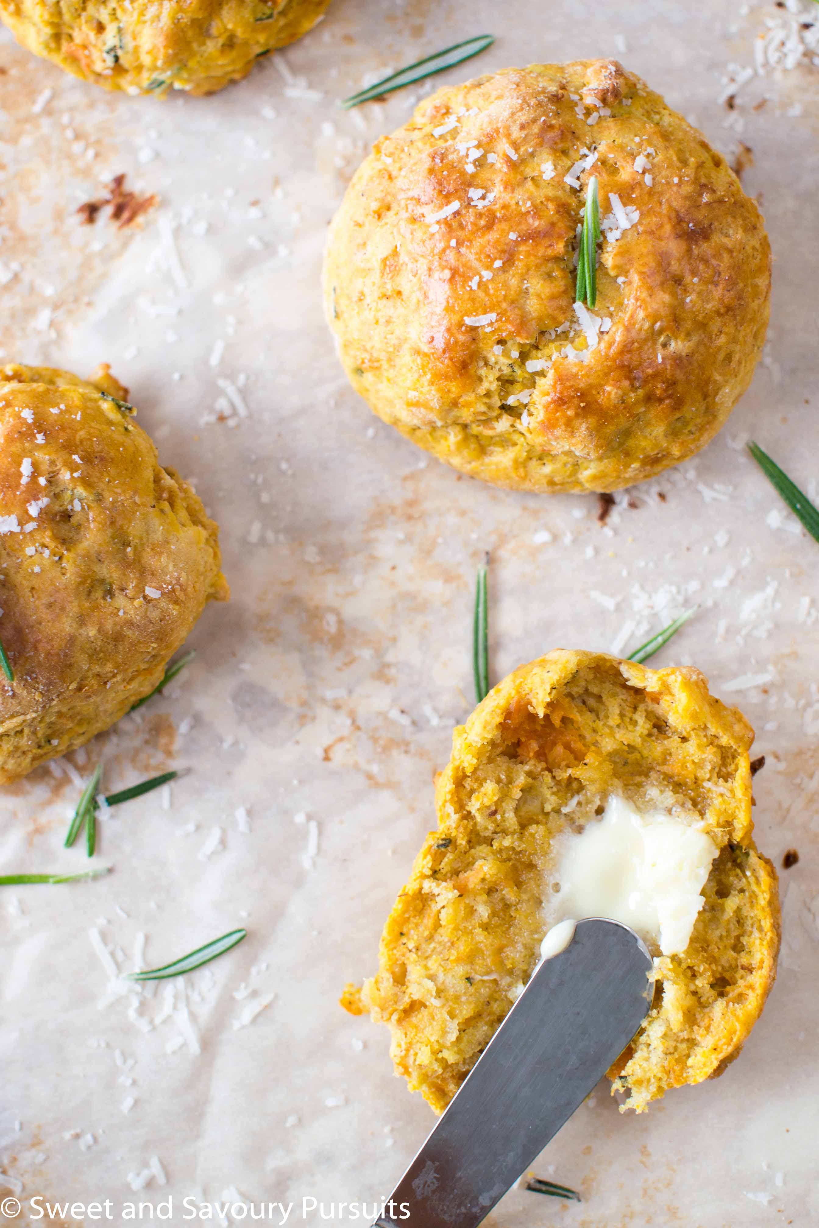 Sweet Potato, Parmesan and Rosemary Biscuit cut in half with butter.