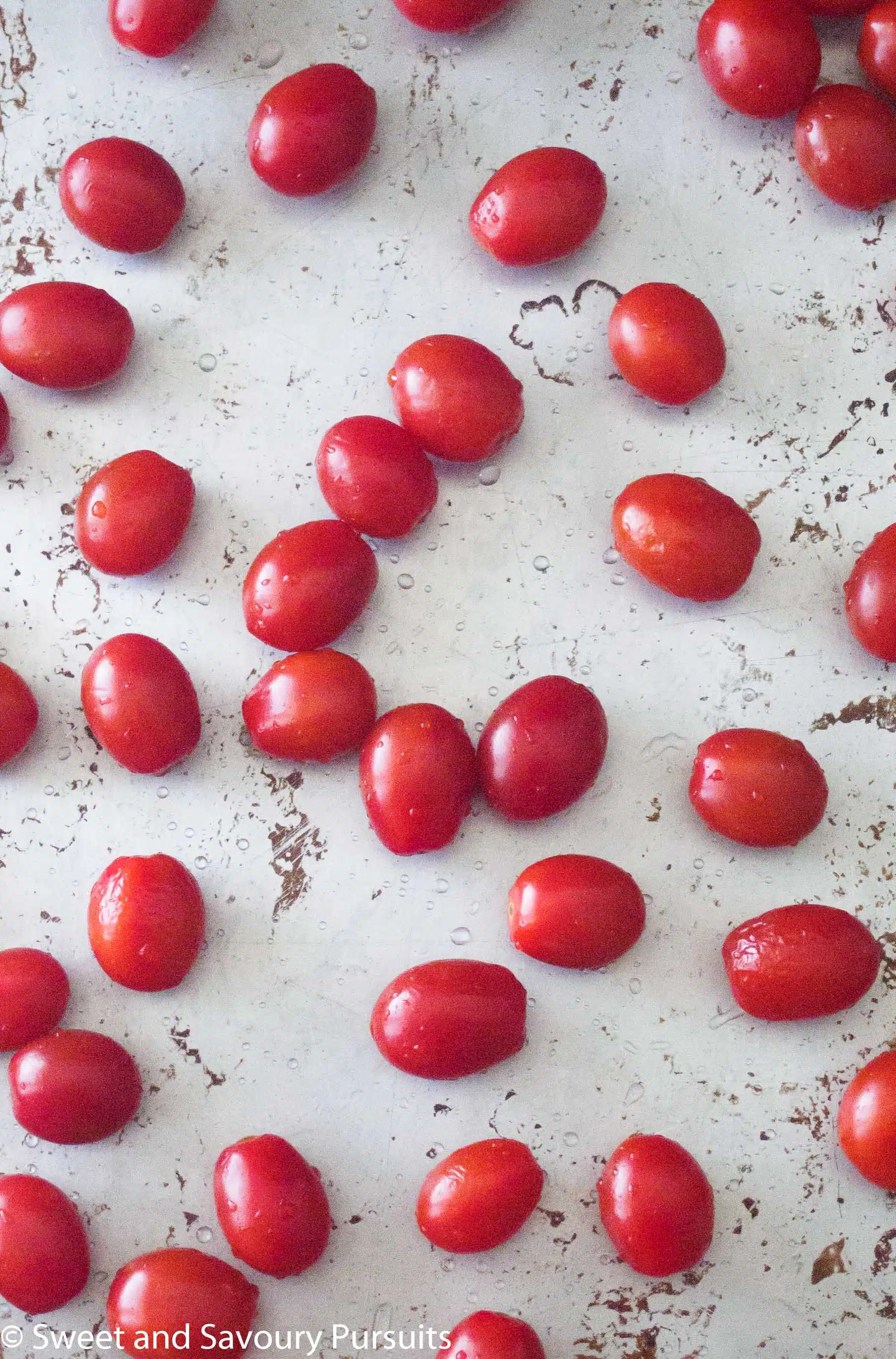 Fresh tomatoes on baking tray.