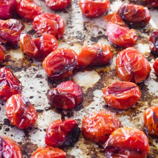 Roasted caramelized tomatoes on baking tray.