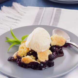 Blueberry cobbler topped with vanilla ice cream.