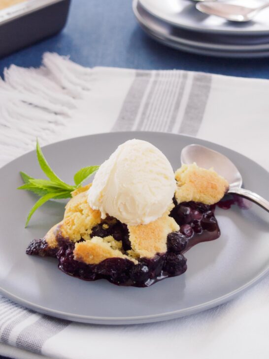 Blueberry cobbler topped with vanilla ice cream.