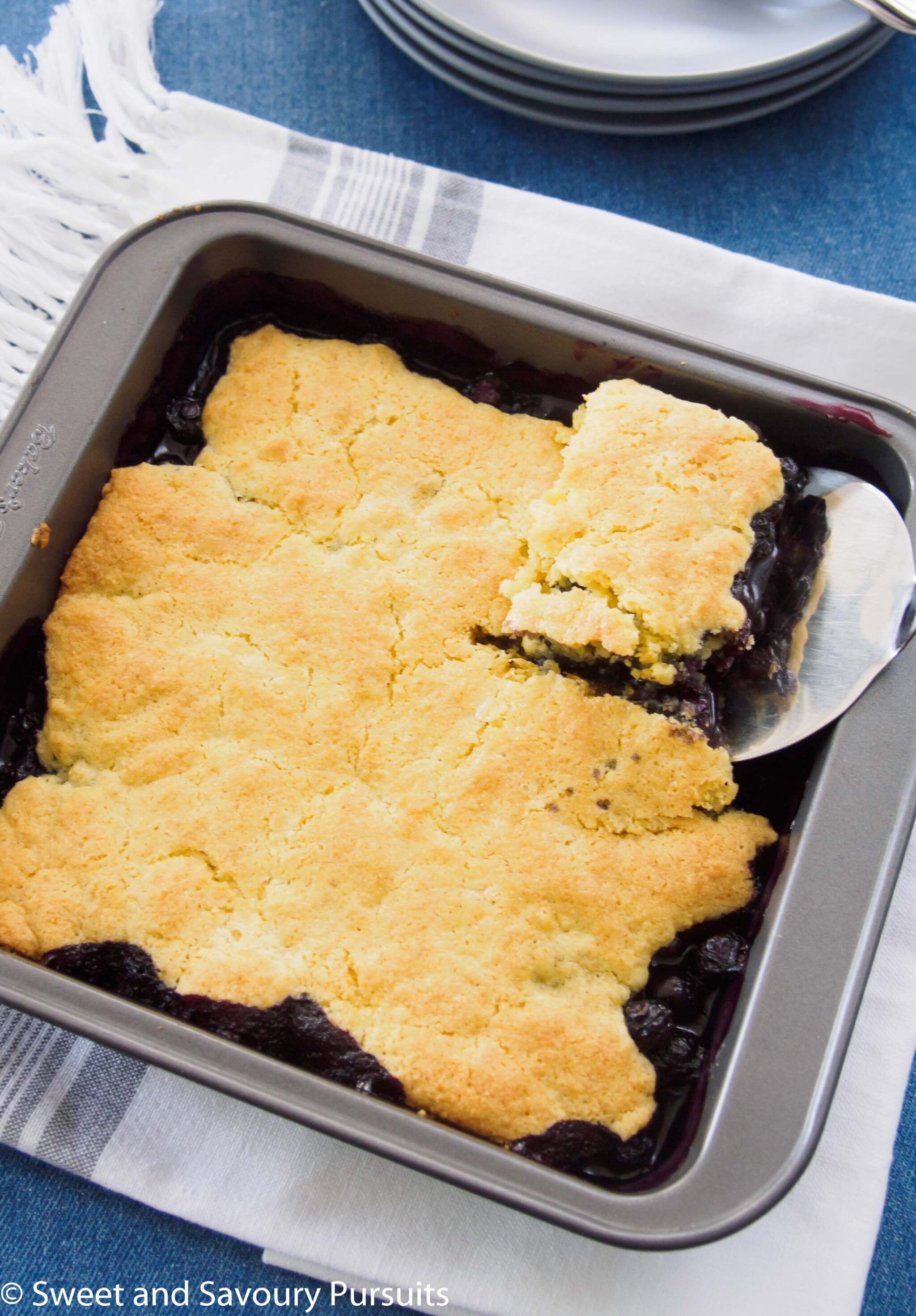 Top view of a baked blueberry cobbler.