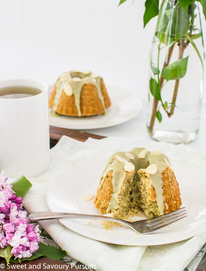 Two plated mini almond matcha bundt cakes.