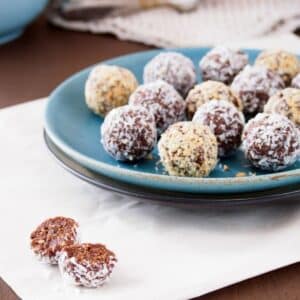 Energy balls made with dates and peanut butter on dish.