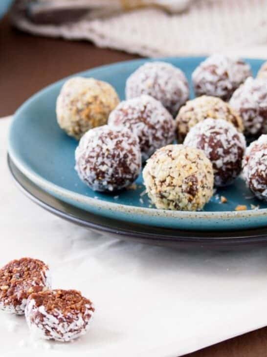 Energy balls made with dates and peanut butter on dish.
