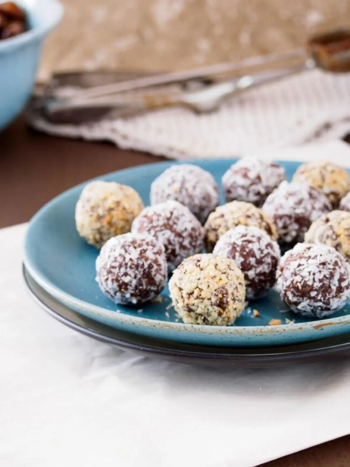 Energy balls made with dates and peanut or almond butter on dish.
