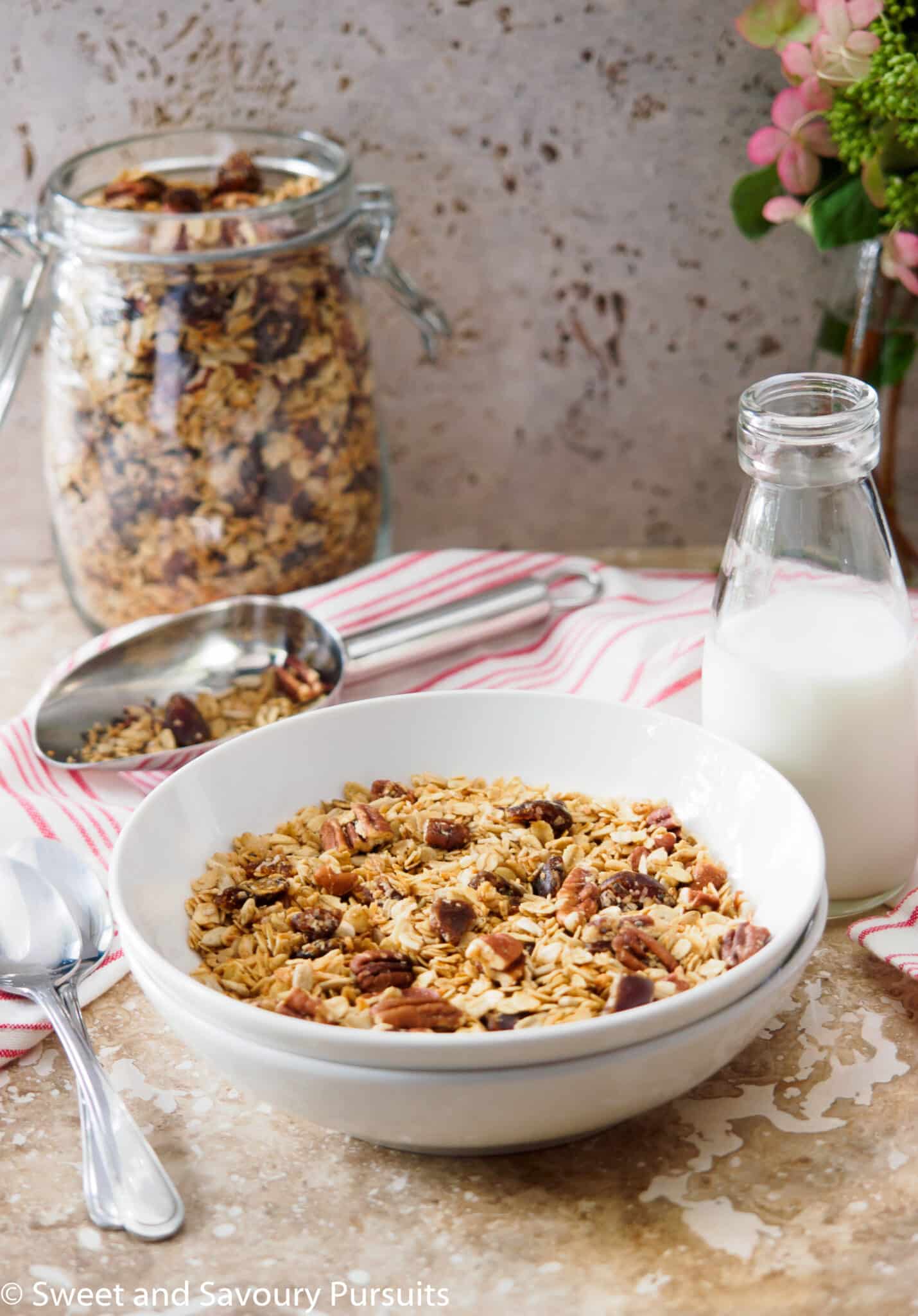 Bowl of vegan maple pecan granola with dates.