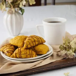 Plate of Pumpkin Scones on tray served with a cup of coffee.