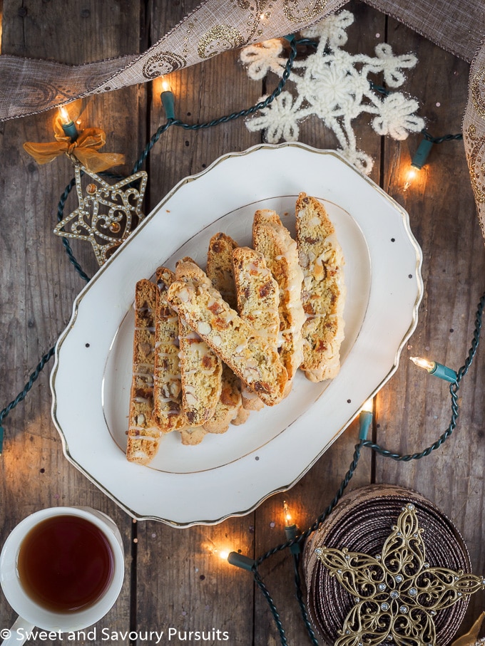 Apricot and Almond Biscotti with White Chocolate Drizzle on serving plate.