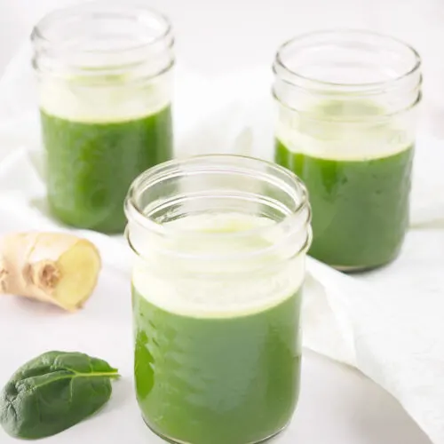 Pineapple Spinach Juice with Ginger served in small mason jars.