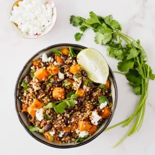 Top view of a bowl filled with sweet potato, black beans and quinoa.