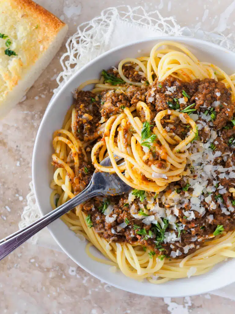 Bowl of spaghetti topped with meat sauce.