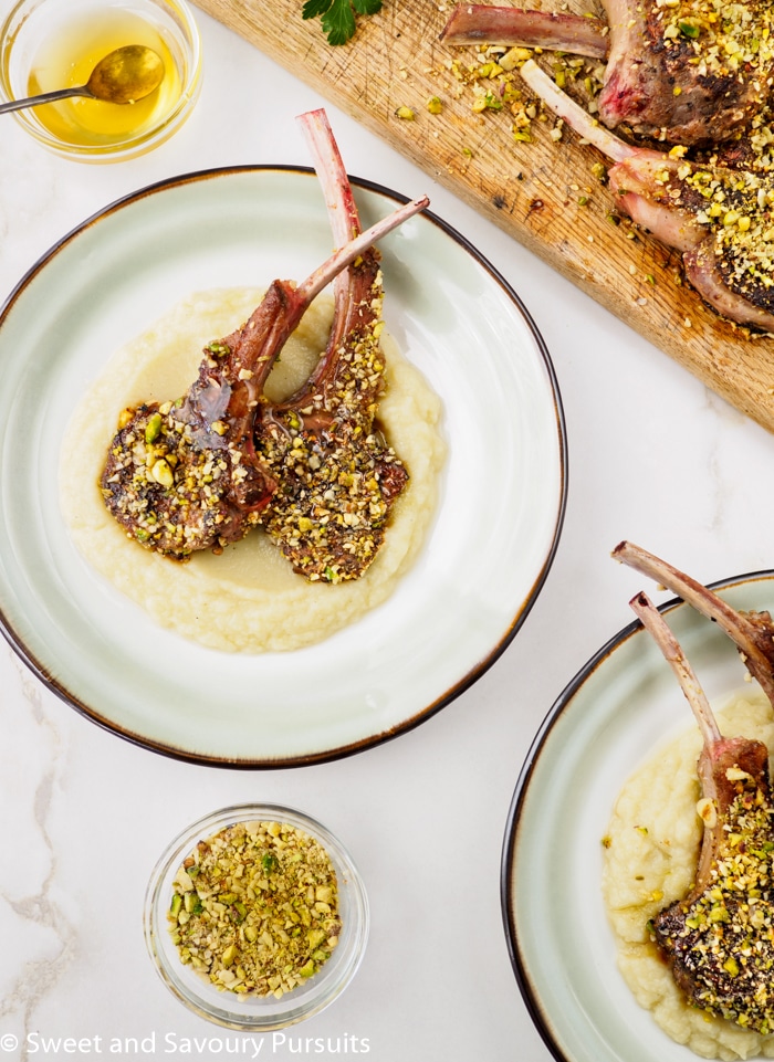 Dukkah-crusted lamb chops served with cauliflower and potato purée.