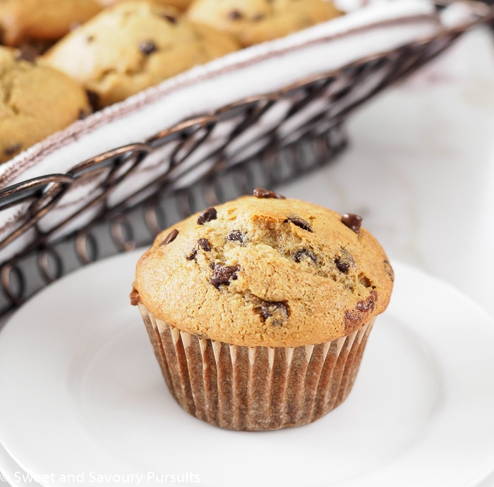 Banana muffin on small white dish.