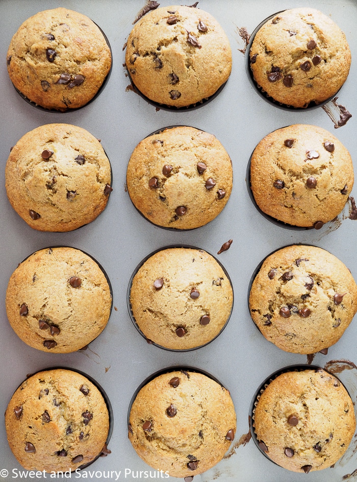 Banana chocolate chip muffins in muffin pan.