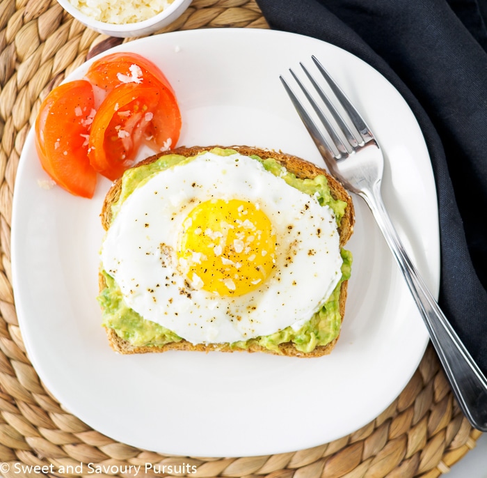 Avocado toast topped with fried egg.