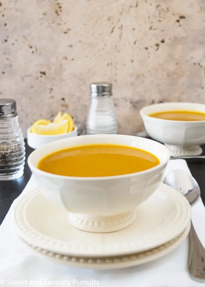 Two bowls of pureed curried sweet potato and lentil soup.