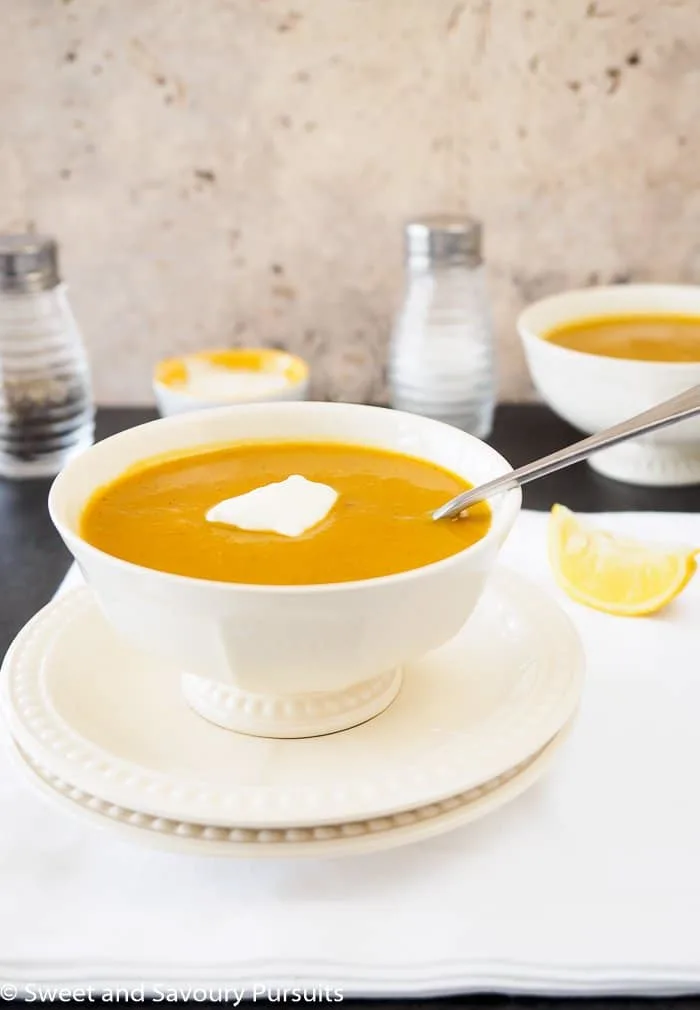 Bowl of Sweet Potato Red Lentil Soup topped with a dollop of yogurt.