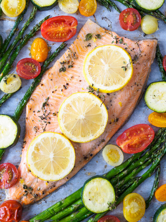 Baked Rainbow Trout Fillet with asparagus, cherry tomatoes and zucchini baked all on one tray.