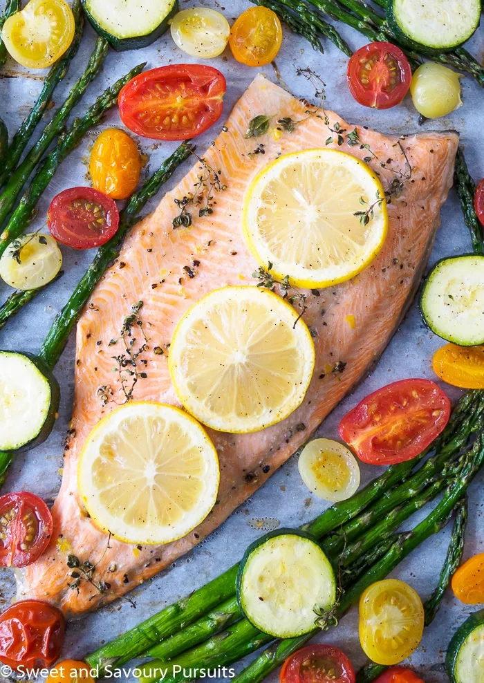 Baked Rainbow Trout Fillet with asparagus, cherry tomatoes and zucchini baked all on one tray.