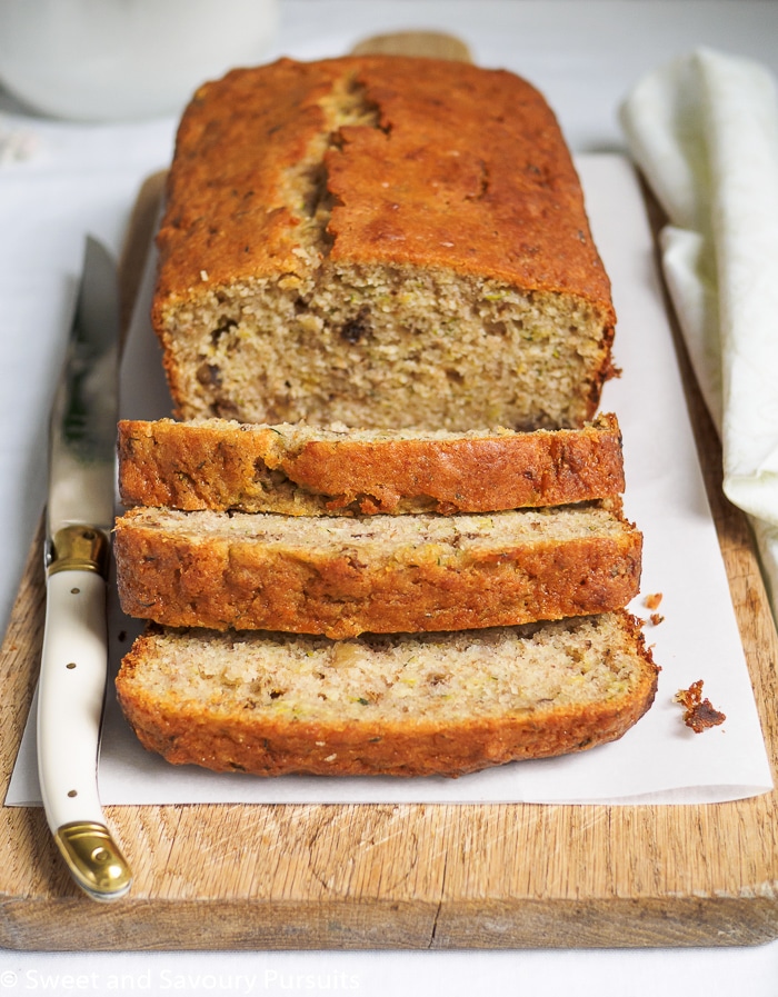 Close-up of a Sliced Lemon Zucchini Loaf on cutting board.