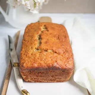 A Lemon Zucchini Loaf on a cutting board.