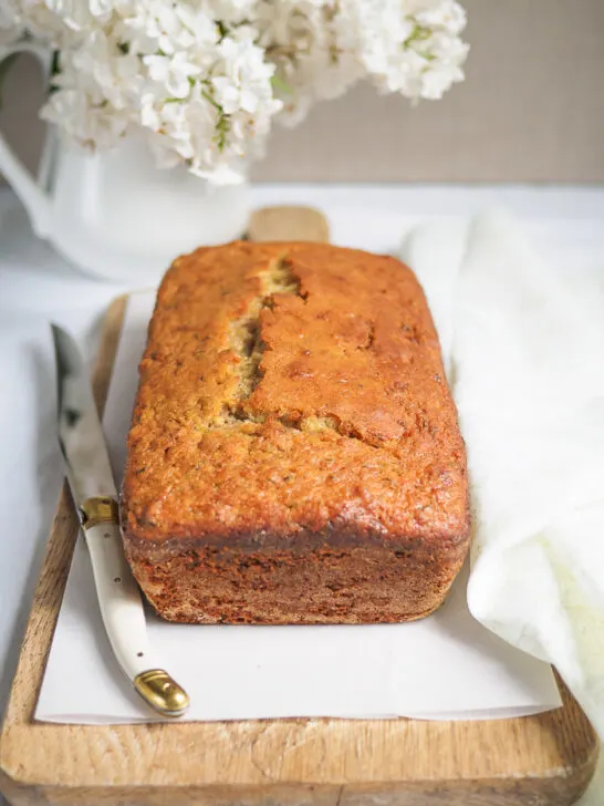 A Lemon Zucchini Loaf on a cutting board.