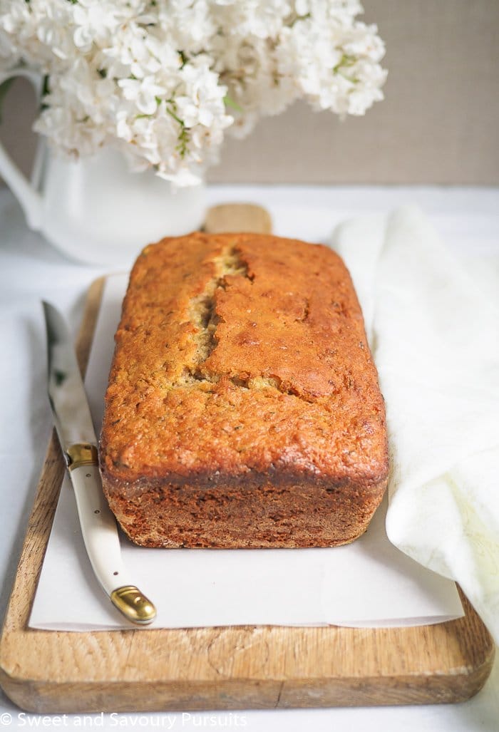 A Lemon Zucchini Loaf on a cutting board.