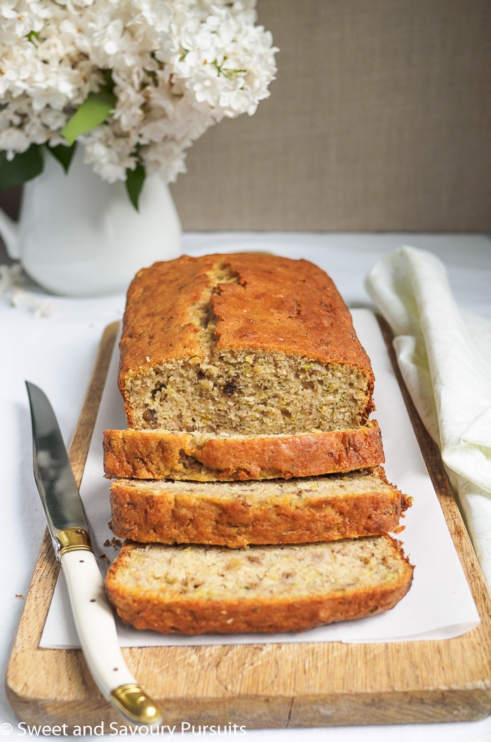 Sliced zucchini walnut bread on cutting board.