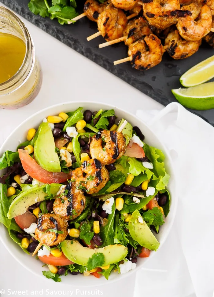 Southwestern Grilled Shrimp Salad served with extra southwest vinaigrette and lime wedges on the side.