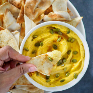 A close up of a chip with White Bean Dip on it.